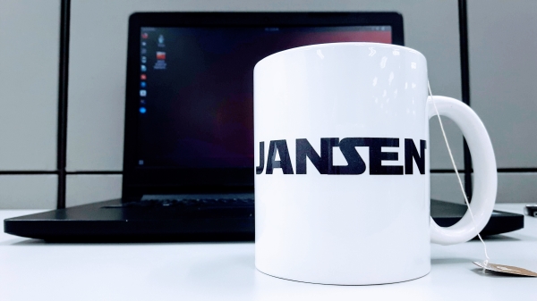 A white cup with tag name Jansen